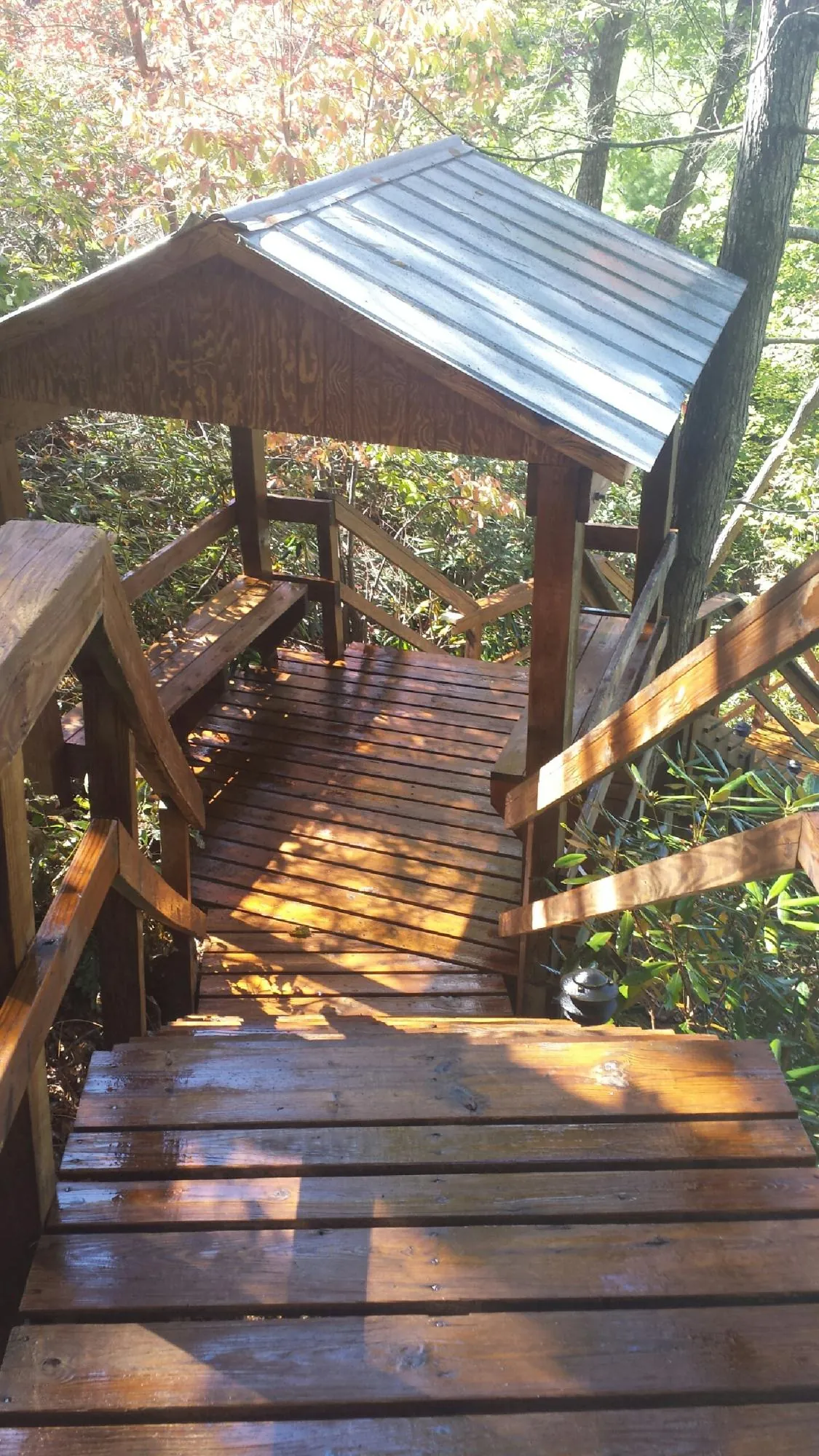 Freshly stained wood walkway and covered shelter with a metal roof in Howells